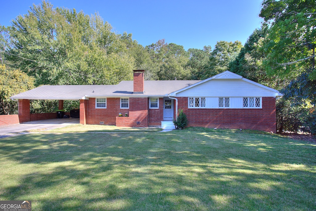 single story home with a front lawn and a carport