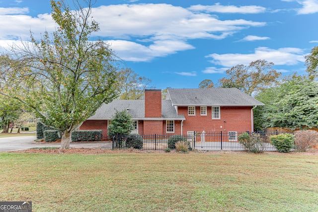 rear view of property with a lawn