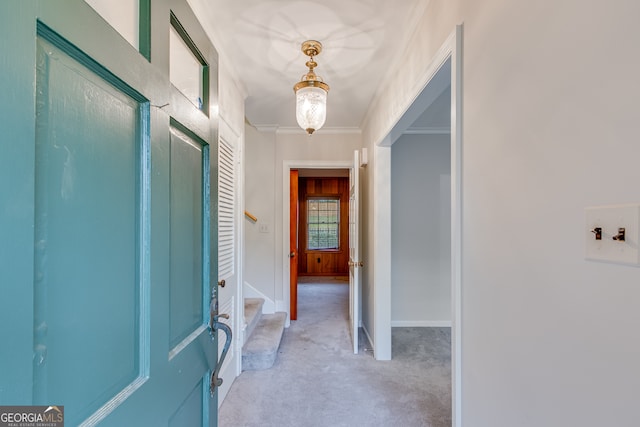 hallway with light colored carpet and crown molding