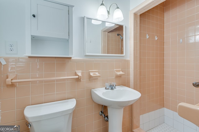 bathroom with toilet and tile walls