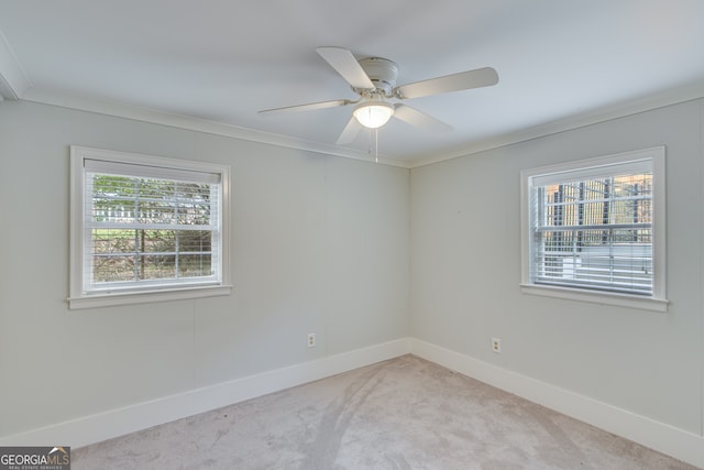 unfurnished room featuring light colored carpet, ceiling fan, and crown molding