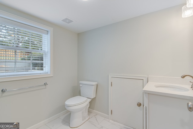 bathroom with toilet and vanity