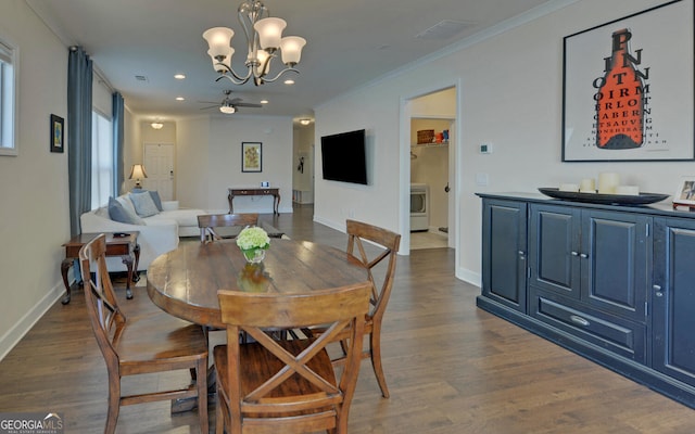 dining space with ornamental molding, dark wood-type flooring, and ceiling fan with notable chandelier