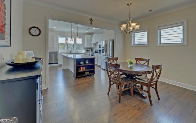 dining space featuring ornamental molding and dark hardwood / wood-style flooring