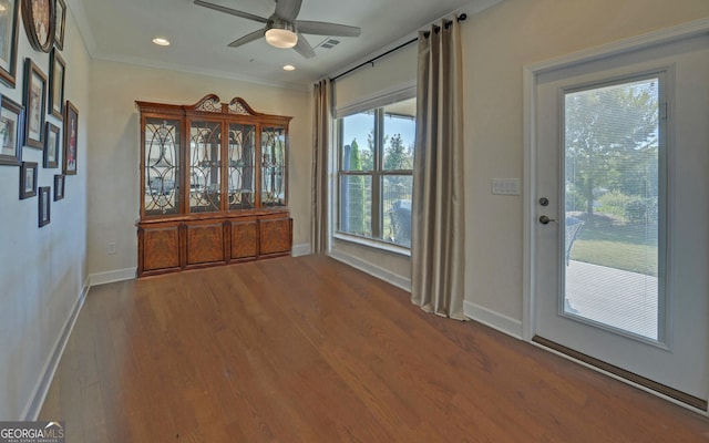 entryway with ceiling fan, wood-type flooring, and ornamental molding