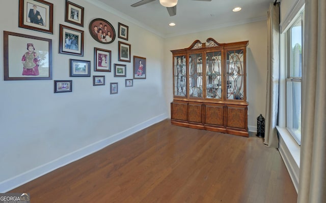 interior space featuring ornamental molding, hardwood / wood-style flooring, and ceiling fan