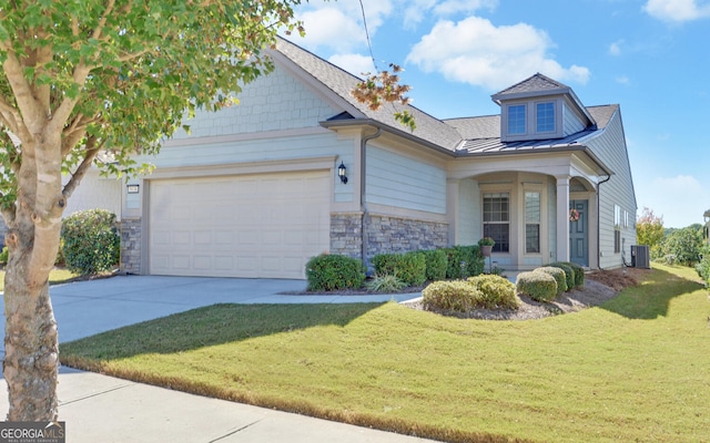 view of front of house featuring a front lawn, central AC unit, and a garage