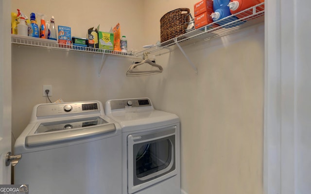 clothes washing area featuring separate washer and dryer