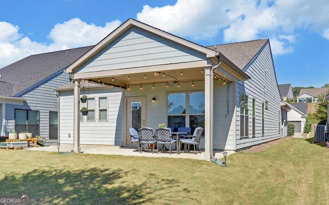 rear view of property with a patio and a lawn