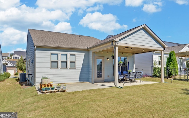 rear view of property featuring a patio, a yard, and central air condition unit