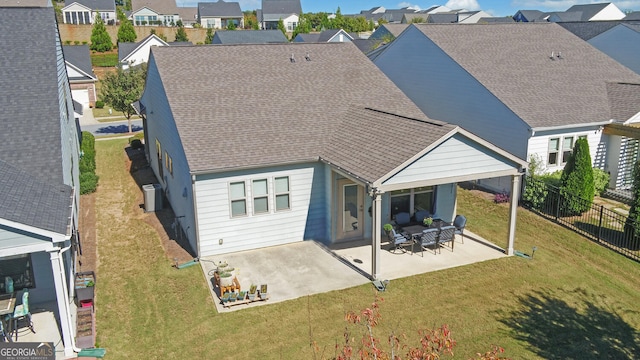 rear view of property featuring a patio area and a lawn