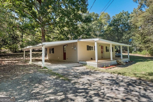 view of front facade with covered porch and a carport