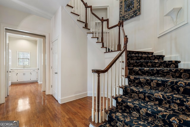 stairway featuring hardwood / wood-style floors