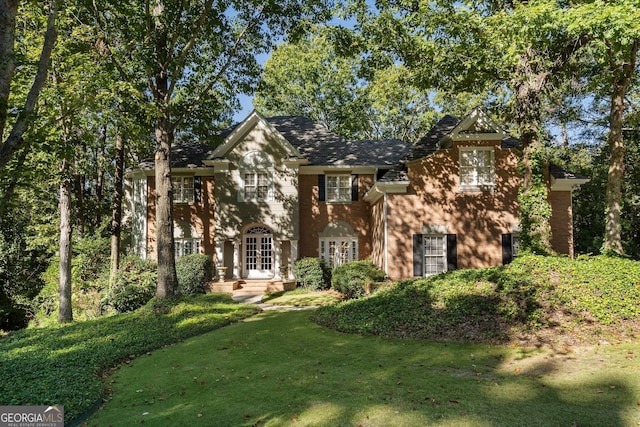 view of front facade featuring french doors and a front lawn