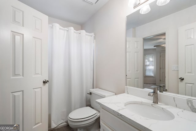 bathroom with vanity, toilet, and walk in shower