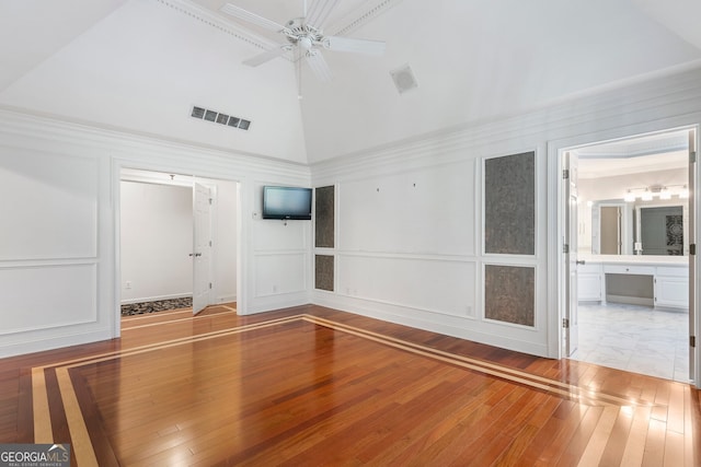 interior space featuring wood-type flooring, high vaulted ceiling, and ceiling fan