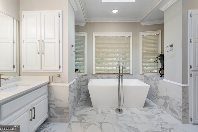 bathroom with a skylight, a tub, tile walls, vanity, and ornamental molding