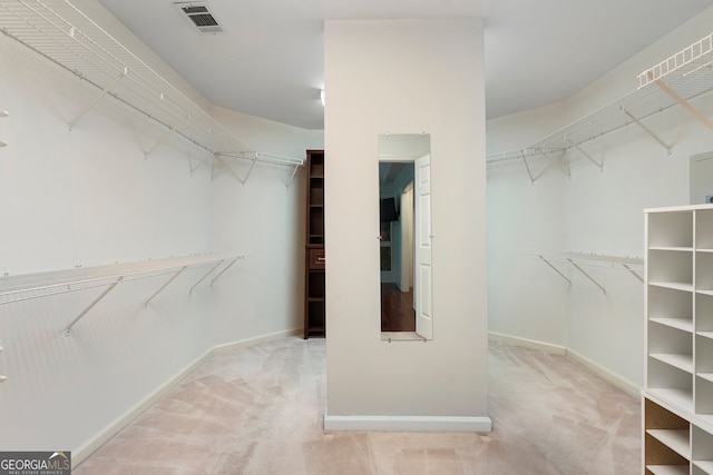 walk in closet with carpet floors