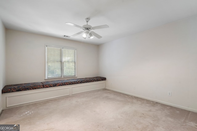 spare room featuring light carpet and ceiling fan