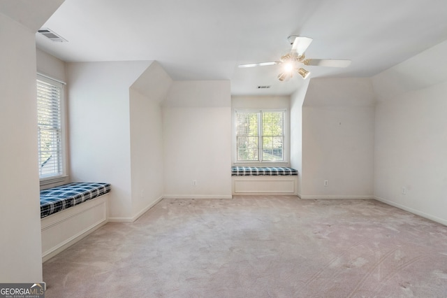 bonus room with light colored carpet and ceiling fan