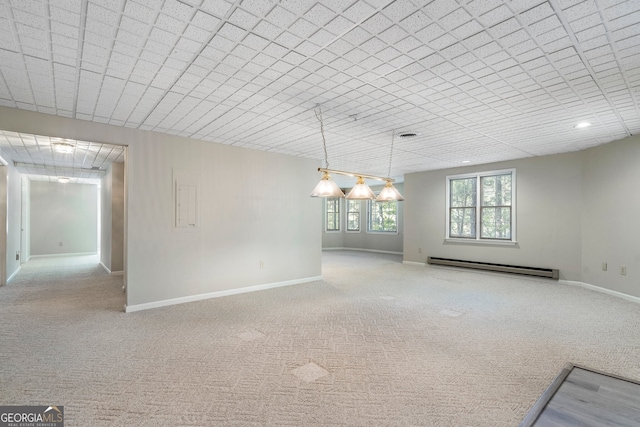 empty room with a baseboard radiator and light carpet