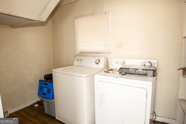 clothes washing area featuring washing machine and dryer and dark hardwood / wood-style floors