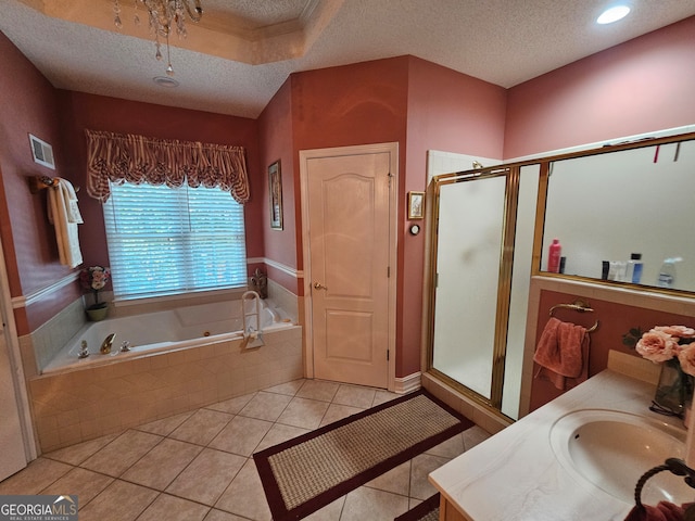 bathroom with vanity, independent shower and bath, a textured ceiling, and tile patterned flooring