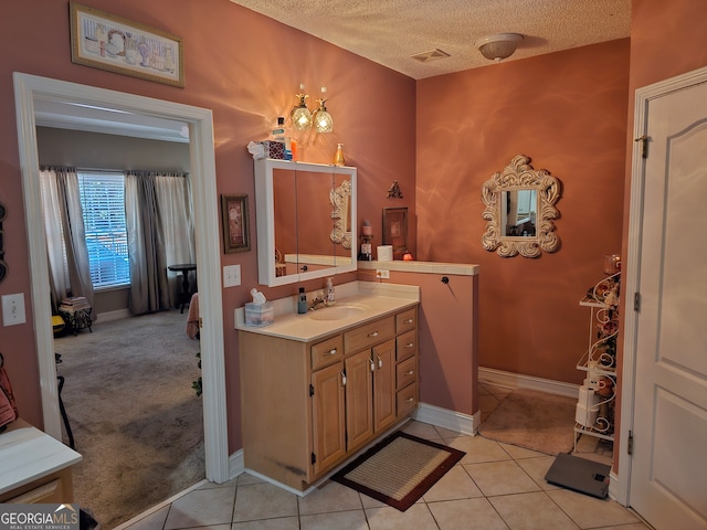 bathroom featuring vanity, a textured ceiling, and tile patterned flooring