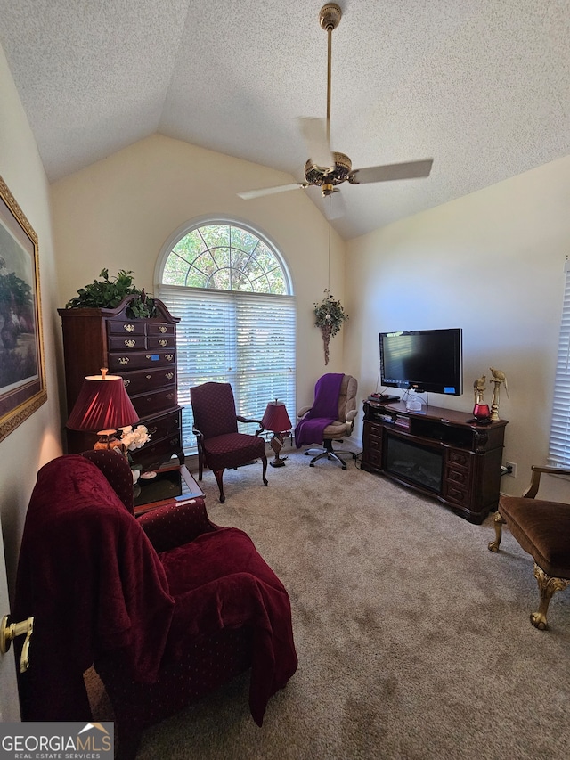 carpeted living room featuring vaulted ceiling and ceiling fan