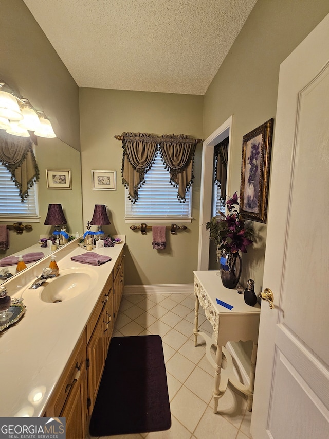 bathroom featuring vanity, a textured ceiling, and tile patterned floors