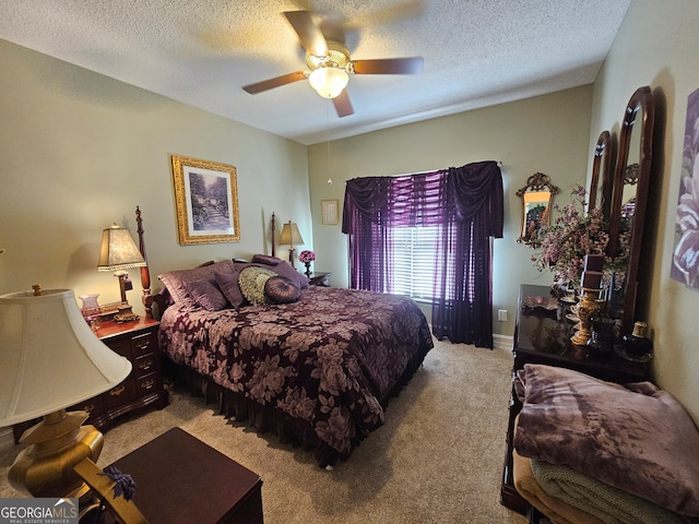 carpeted bedroom featuring a textured ceiling and ceiling fan