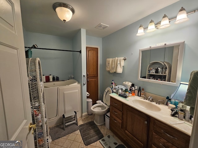 bathroom featuring vanity, toilet, and tile patterned floors