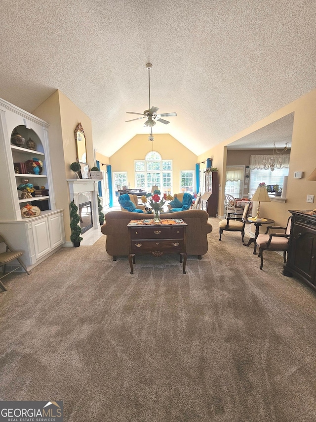 carpeted living room with ceiling fan, a textured ceiling, and lofted ceiling