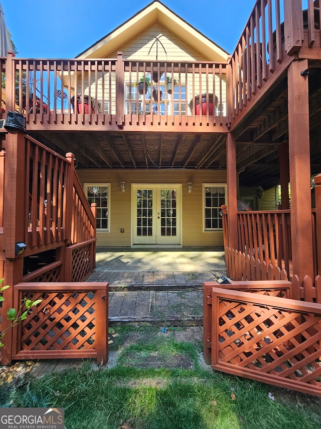 back of property featuring a deck and a patio area