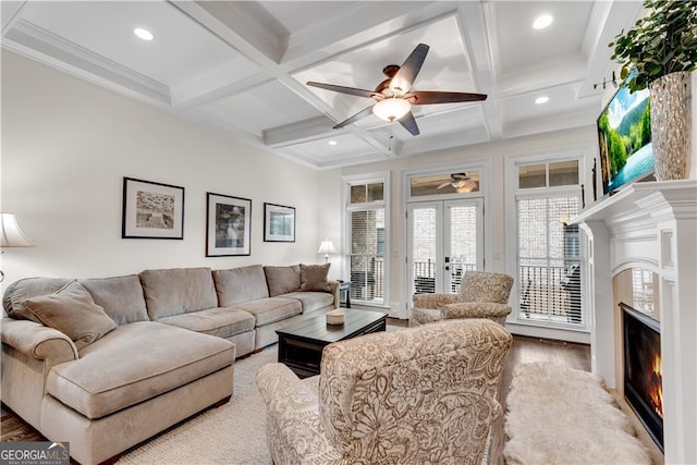 living room featuring beam ceiling, coffered ceiling, and light hardwood / wood-style flooring