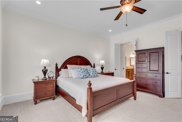 bedroom featuring connected bathroom, crown molding, light colored carpet, and ceiling fan