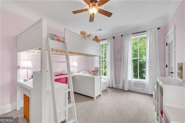 carpeted bedroom with ceiling fan and crown molding