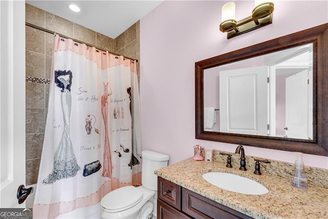 bathroom with toilet, curtained shower, and vanity