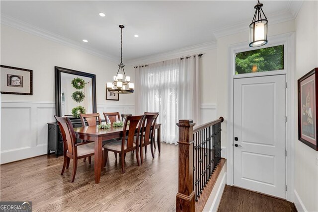 3637 Habersham Rd NW Unit 46, Atlanta, GA 30305 - dining space with healthy amount of natural light, a chandelier, a decorative wall, ornamental molding, and wood finished floors
