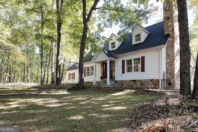 cape cod home with a front lawn