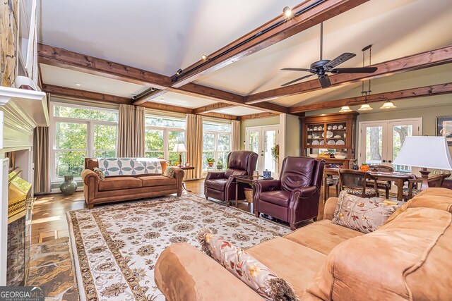 living room featuring a wealth of natural light, french doors, and ceiling fan