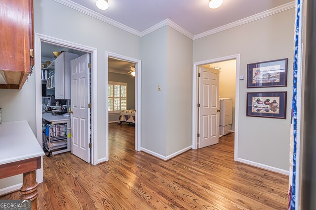 hall featuring hardwood / wood-style flooring and crown molding