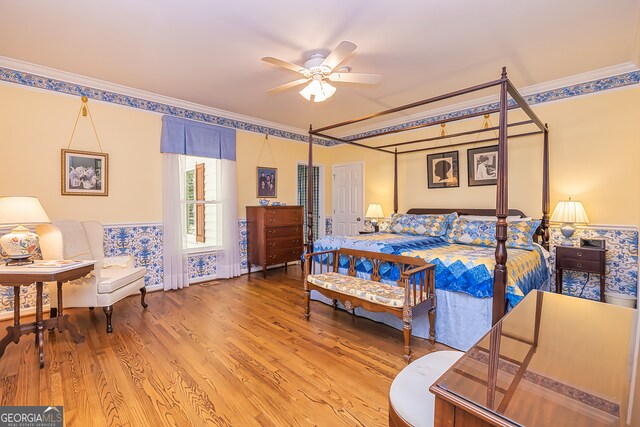 bedroom featuring ornamental molding, hardwood / wood-style floors, and ceiling fan