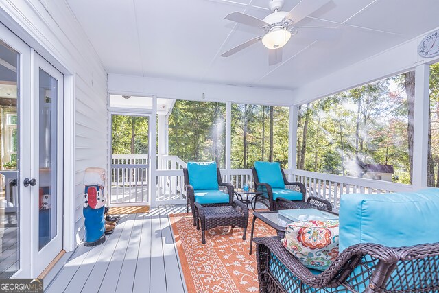 sunroom featuring ceiling fan