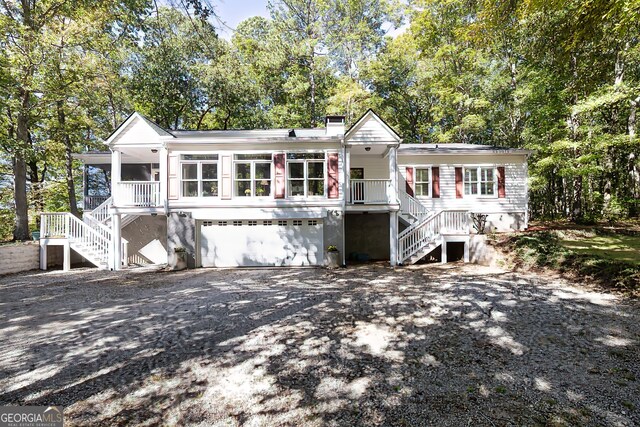 view of front of home featuring a garage and a sunroom