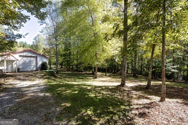 view of yard with a garage and an outdoor structure