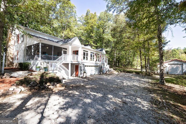 view of front of property with a garage and a sunroom