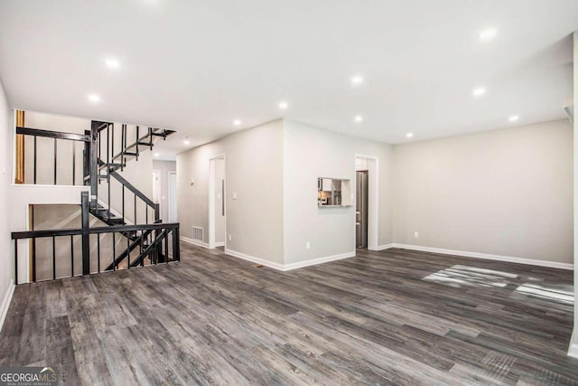 unfurnished living room with dark hardwood / wood-style floors