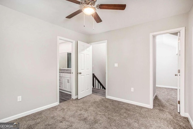 unfurnished bedroom with connected bathroom, carpet floors, and ceiling fan