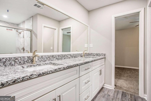 bathroom featuring vanity, wood-type flooring, and an enclosed shower